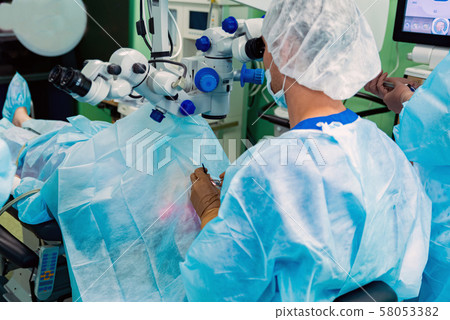 Doctors perform eye lens replacement operation with modern equipment 58053382