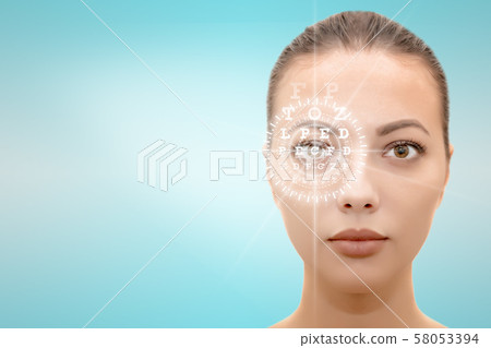 Isolated face of young beautiful woman with hi-tech laser eye surgery concept Isolated face of young beautiful woman with hi-tech laser eye surgery concept 58053394