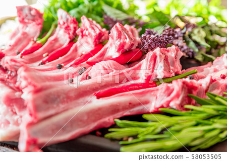 Raw lamb ribs on kitchen table ready to be cooked Raw lamb ribs on kitchen table ready to be cooked 58053505