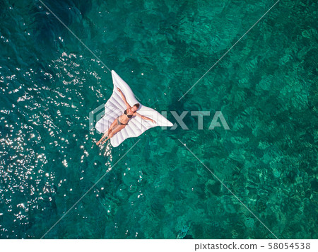 Turquoise ocean water and relaxed swimming woman, Turquoise ocean water and relaxed swimming woman, 58054538