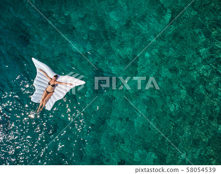 Turquoise ocean water and relaxed swimming woman, Turquoise ocean water and relaxed swimming woman, 58054539