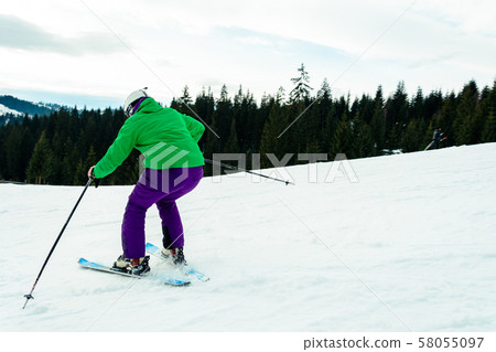A young man is skiing in the Carpathians on the 58055097