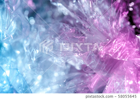 Holographic background in the style of the 80-90s. Real texture of cellophane film in bright acid 58055645
