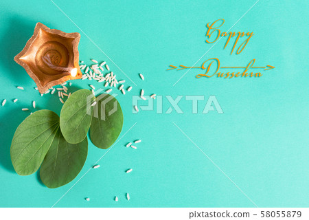 Happy Dussehra. Clay Diya lamps lit during, Dussehra Indian Festival concept. Happy Dussehra. Clay Diya lamps lit during, Dussehra Indian Festival concept. 58055879