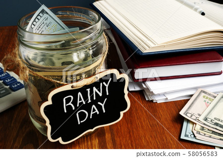 Rainy Day Fund label on the jar with money. 58056583