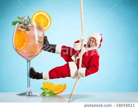 Happy Christmas Santa Claus climbing on rope on blue background Happy Christmas Santa Claus climbing on rope on blue background 58058011