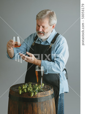 Confident senior man brewer with self crafted beer Confident senior man brewer with self crafted beer 58058179