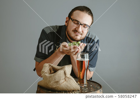 Confident young male brewer with self crafted beer Confident young male brewer with self crafted beer 58058247