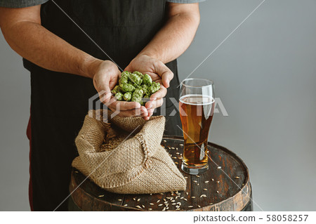 Close up of confident young man brewer with self crafted beer 58058257