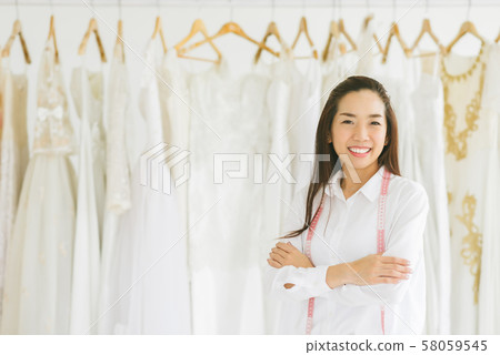 Happy successful wedding dress shop owner Happy successful wedding dress shop owner 58059545