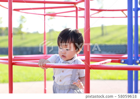 2-year-old boy playing athletic in the park 58059618