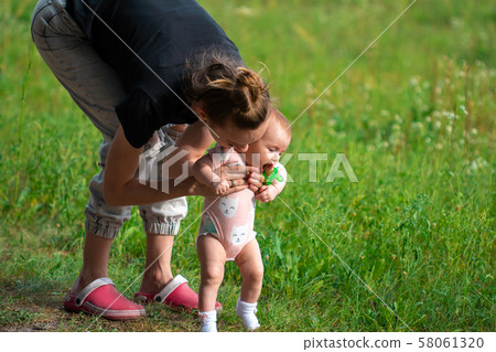 mother with her little baby girl having fun in the mother with her little baby girl having fun in the 58061320