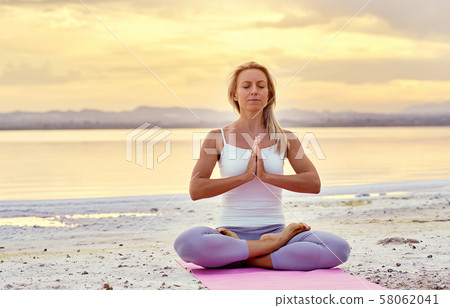 Woman do meditation outdoors 58062041