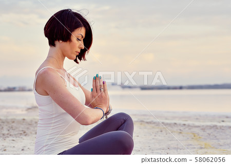Woman meditating outdoors 58062056