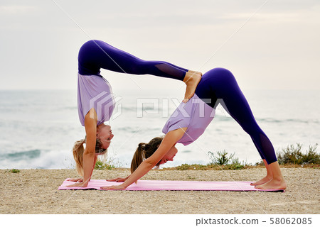 Women do Downward Facing Dog 58062085