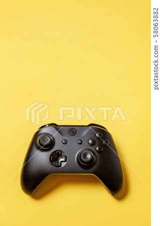 Black joystick on yellow background. Computer 58063882
