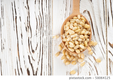 cedar nuts in spoon cedar nuts in spoon 58064125