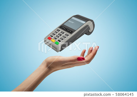 Female hand with PIN pad on blue background 58064145