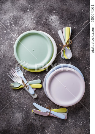 Colorful plastic dishes for summer picnic 58064161