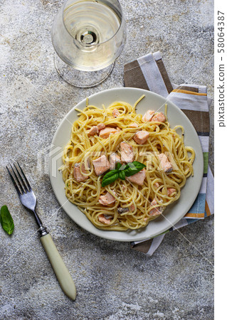 Pasta spaghetti with salmon and basil 58064387