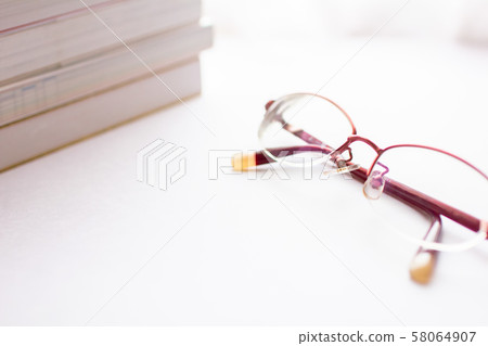 A lot of reference books and red glasses A lot of reference books and red glasses 58064907