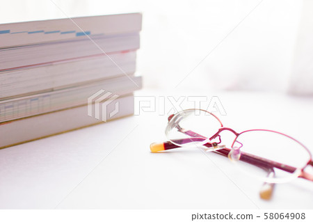 A lot of reference books and red glasses A lot of reference books and red glasses 58064908