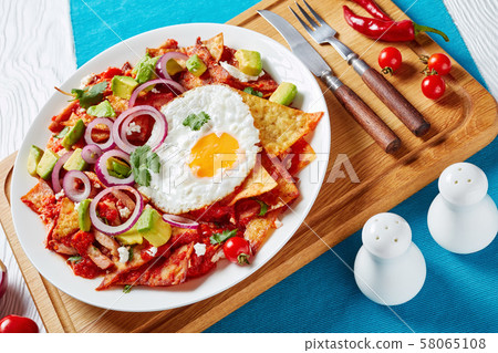 chilaquiles with a fried egg on a plate chilaquiles with a fried egg on a plate 58065108