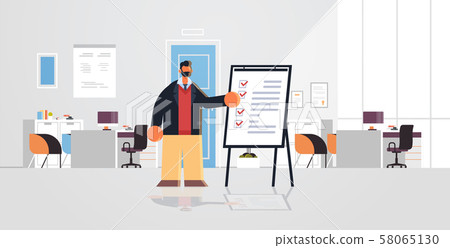 businessman working with check list business man standing near flip chart with questionnaire survey businessman working with check list business man standing near flip chart with questionnaire survey 58065130