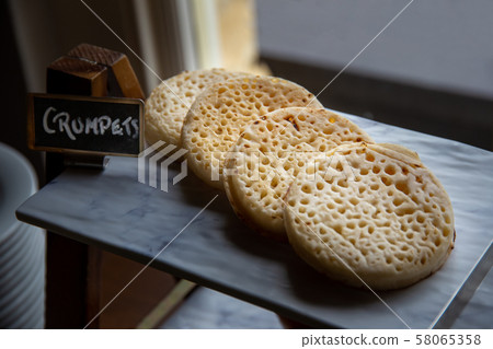 Hot toasted English crumpets 58065358