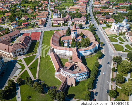 Aerial view of fortified church surrounded powerful thick walls in Transylvania overlooking the 58065628