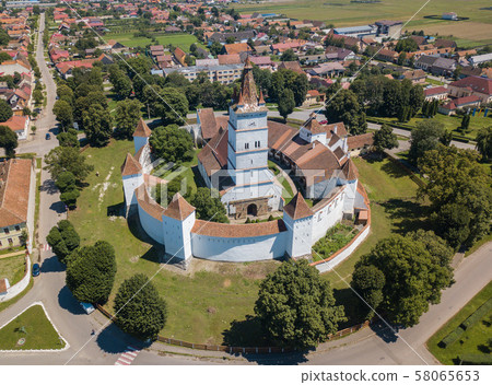 Aerial view of fortified church surrounded powerful thick walls in Transylvania overlooking the 58065653