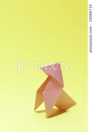 paper bird on yellow background paper bird on yellow background 58066710