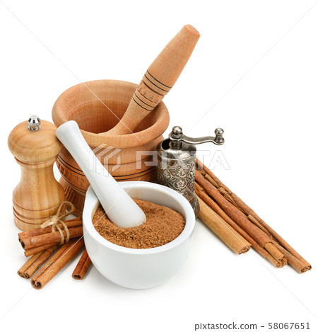Cinnamon, mortar and pestle, hand grinder isolated 58067651