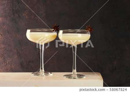 Two glasses of Eggnog decorated with anise stars Two glasses of Eggnog decorated with anise stars 58067824