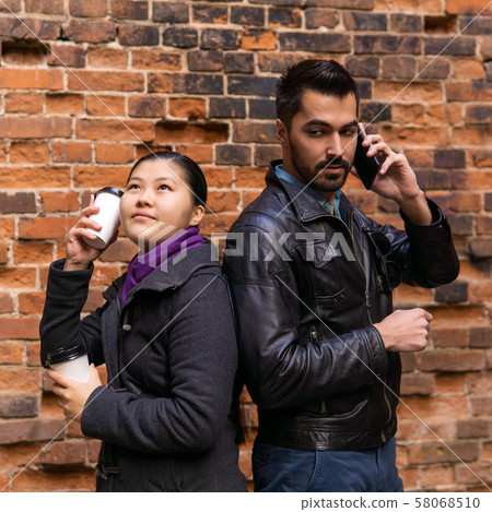 young man is talking on the phone for a long time, young man is talking on the phone for a long time, 58068510