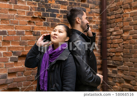 young man and woman stand nearby back to back, young man and woman stand nearby back to back, 58068516