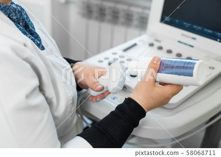 Doctor prepare an ultrasound machine for the 58068711