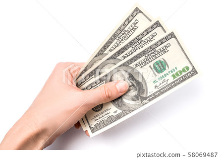 Dollars in woman hand isolated on white background. 58069487
