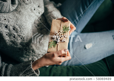 Female hands with decorated Christmas gift box 58069489