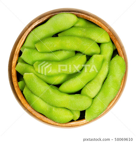 Edamame, green soybeans in the pod, in wooden bowl 58069610