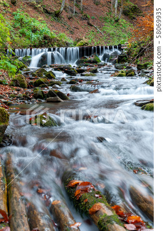 Mountain waterfall in autumn forest 58069935