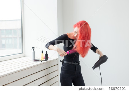 Hairdresser, beauty salon and people concept - young woman hair stylist with hair dryer on white Hairdresser, beauty salon and people concept - young woman hair stylist with hair dryer on white 58070201