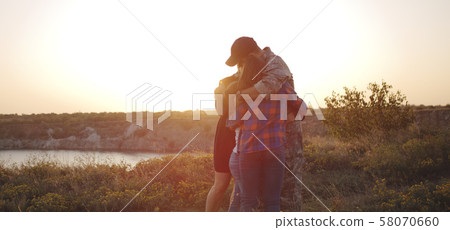Soldier and his family walking on a meadow Soldier and his family walking on a meadow 58070660