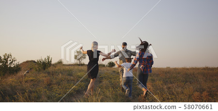 Soldier and his family walking on a meadow Soldier and his family walking on a meadow 58070661
