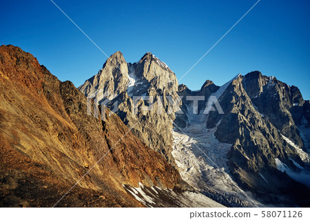 Ushba, a mountain in Svaneti, the village of Mestia Georgia. Ushba, a mountain in Svaneti, the village of Mestia Georgia. 58071126