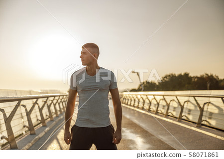 Attractive serious muscular young man looking away Attractive serious muscular young man looking away 58071861