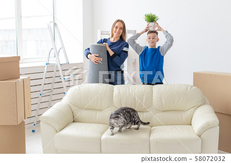 Young cute single mother and son are happy about the move to new house holding a lop-eared scottish 58072032