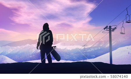 Snowboarder watching the sunset over the mountains. 58074140