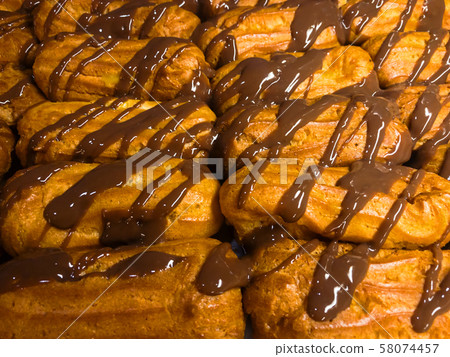 Cream puffs with chocolate closeup Cream puffs with chocolate closeup 58074457