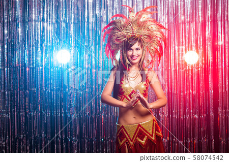 Cabaret, dancer and holidays concept - Cute young girl in bright colorful carnival costume on dark Cabaret, dancer and holidays concept - Cute young girl in bright colorful carnival costume on dark 58074542